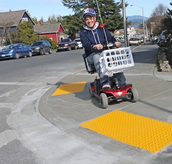 A contoured ramp at the intersection of Blair Avenue and Spring Street helps Aaron D'Errico navigate his motorized wheelchair through the streets of Friday Harbor with greater ease and safety.