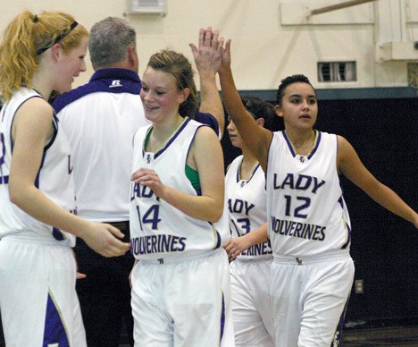 Liz Taylor (12) high-fives Coach Eric Jangard during the Wolverines’ 50-19 roll-over win vs. Shoreline Christian