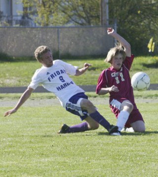 Friday Harbor's Conor Lanphere and Cavelero's Kevin Laughlin battle for the ball in the second period of the teams' soccer game