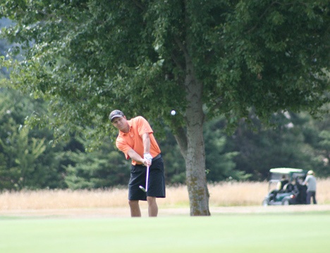 Bobby Tangney chips onto the green of the 13th hole Sunday at San Juan. He and Bobby Erickson