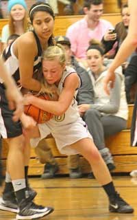 Friday Harbor's Emily Guard wrestles with Blaine's Mandy Hays for possession of the basketball.