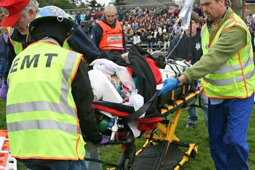 San Juan EMTs remove a girl playing the role of a victim in a deadly DUI crash from the Friday Harbor High School football field during Tuesday's the island's third staging of 'Every 15 Minutes' program.