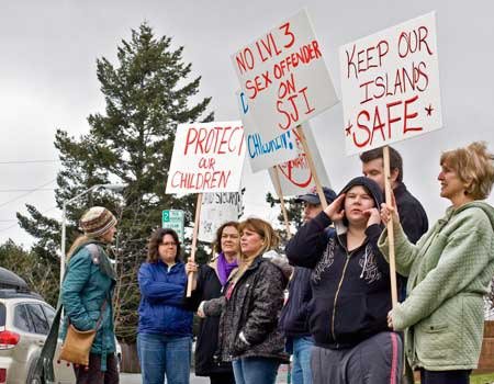 Two demonstrations — similar to the one in the accompanying photo — are planned for Tuesday on the court house lawn. The protests coincide with a visit by to San Juan Island by a high-ranking official of the state Department of Corrections