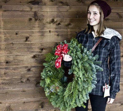 Friday Harbor High School senior Jenny MacDonald holds a wreath being sold as the annual fundraiser for the drug and alcohol free Grad Night party in June 2012.