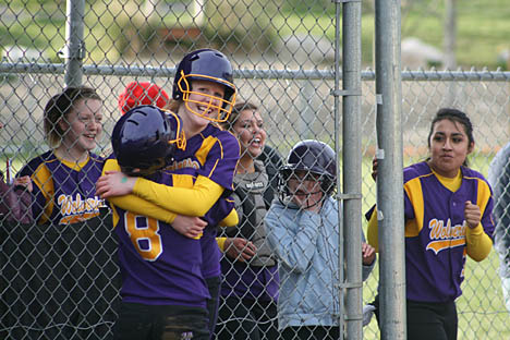 Maggie Andersen and her teammates celebrate after her three-run in-the-park home run