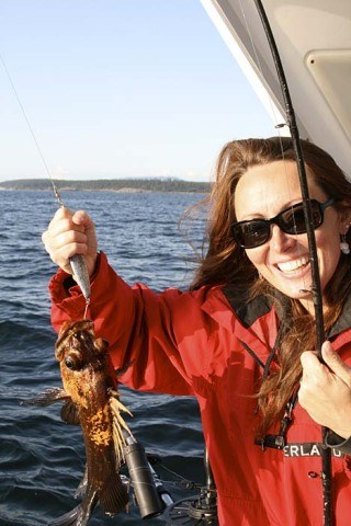 Kris Rasmussen shows off the rockfish she reeled in Aug. 30 near Cattle Pass.  Rockfish harvests in this area are managed by the state and the commercial catch has been substantially restricted since the early 1990s