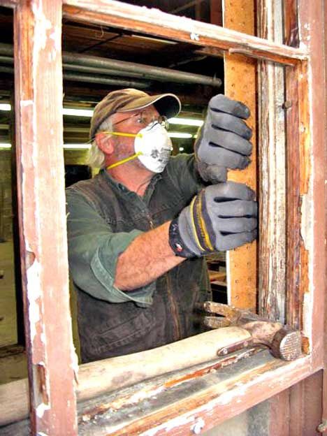 Equipped with a face mask and sturdy gloves for protection