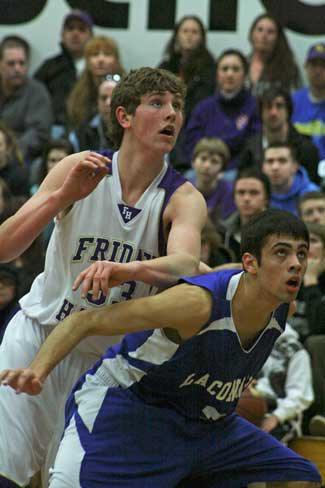 Friday Harbor's Otis Cooper-West fights fights for rebounding position against La Conner's Landy James. Cooper-West