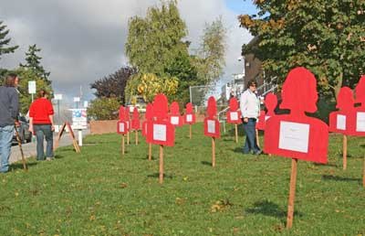 Rows of silhouettes on the county courthouse lawn honor victims and survivors of domestic violence