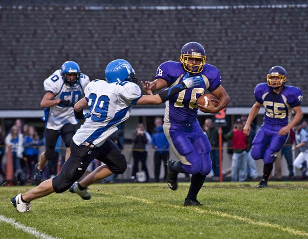 Friday Harbor's Roy Taylor (16) fends off a Viking defender in the first quarter of the Island Cup game