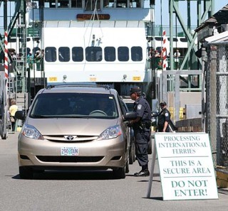 A Customs officer checks a vehicle arriving in Friday Harbor off the international ferry. On Monday