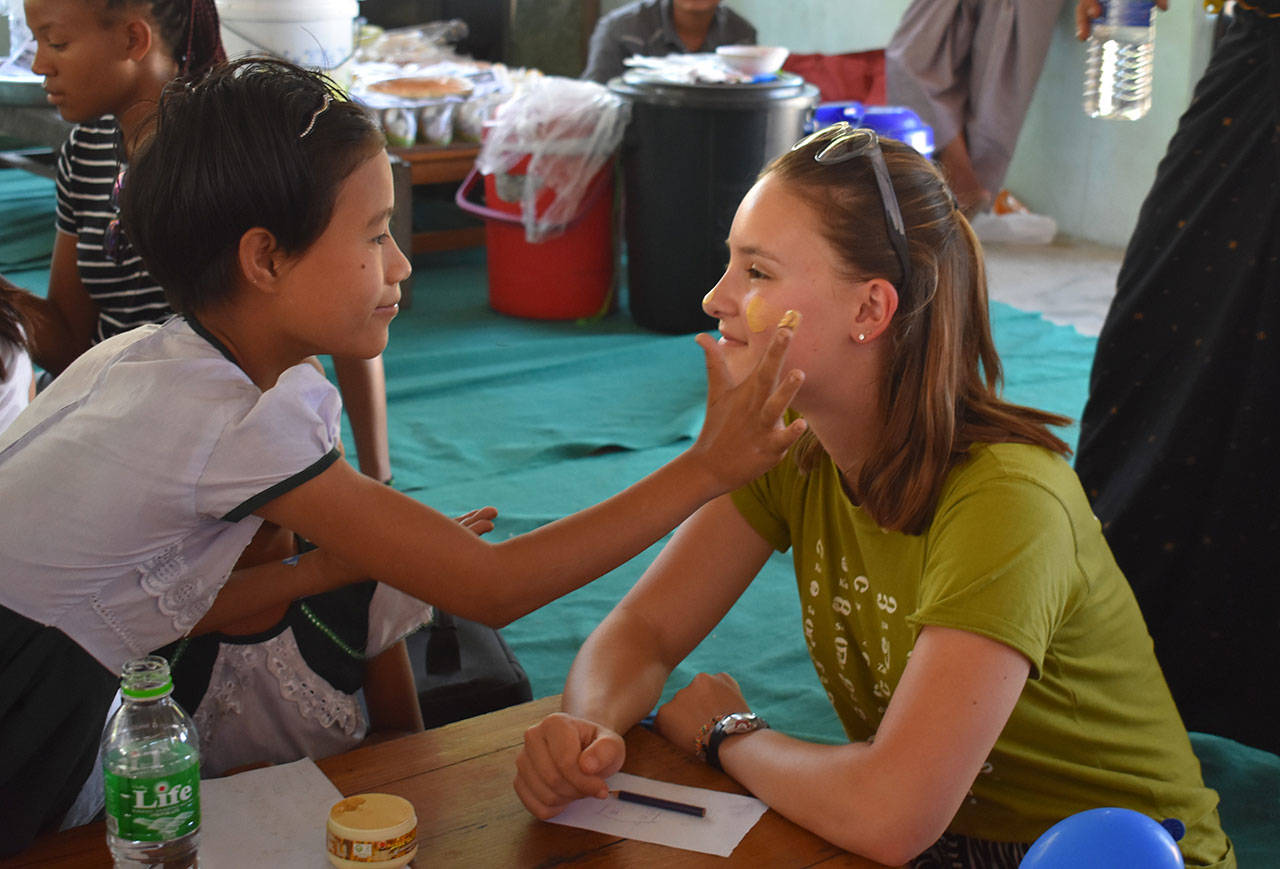 Contributed photo/Karen Meenan                                Natalie Meenan, a sophomore at FHHS, plays with children at a school, which doubles as an orphanage for some. “Impact programs are great,” said Natalie, “but I think the children may be making an even bigger impact on me than I am on them.”