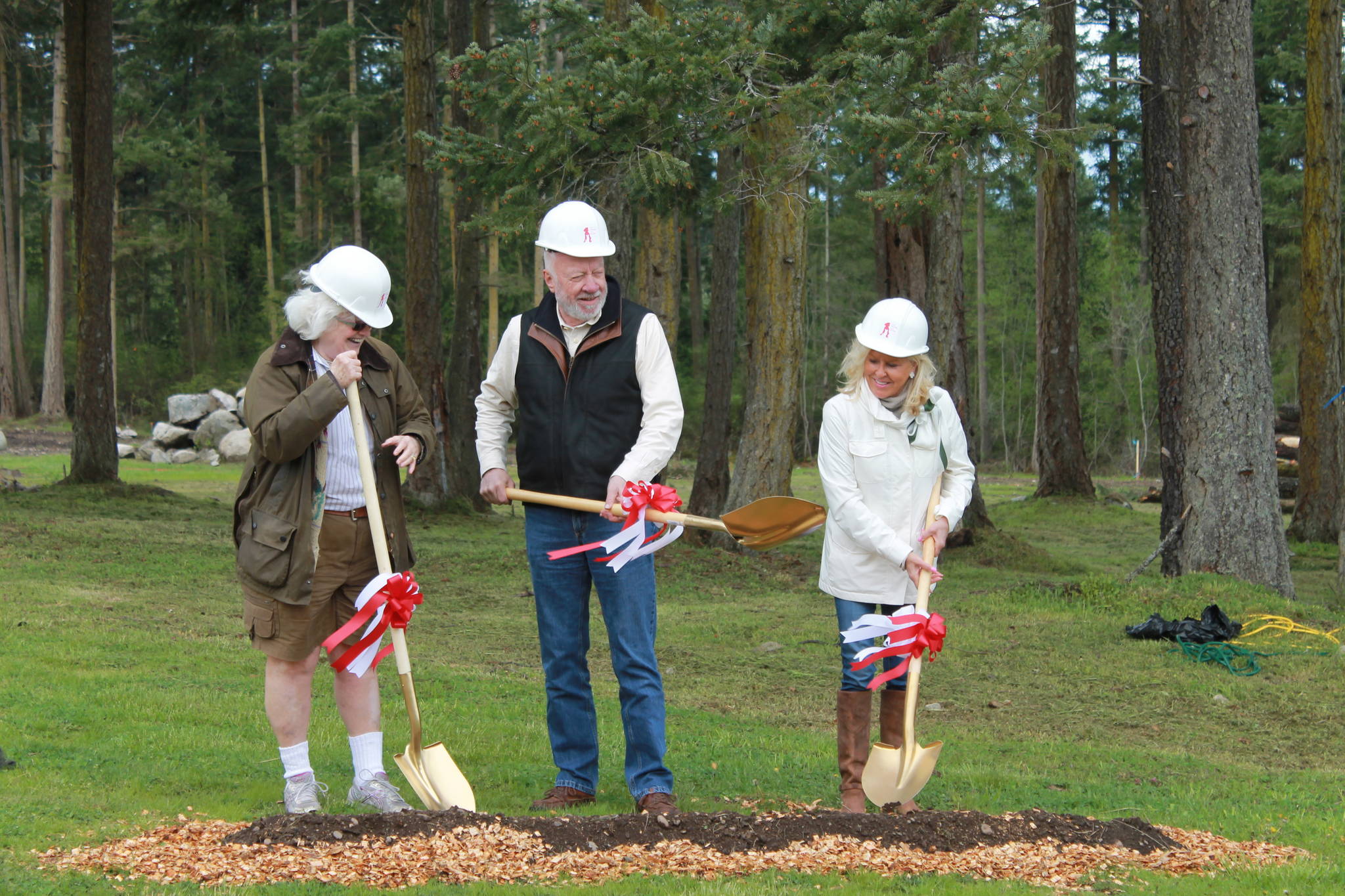 Staff photo/Heather Spaulding                                The McDowells and Rebecca Pohlad break ground with golden shovels.