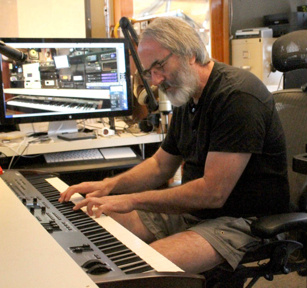 Staff photo/Hayley Day                                Steven Roberts plays his electric keyboard on his 50-foot power boat.