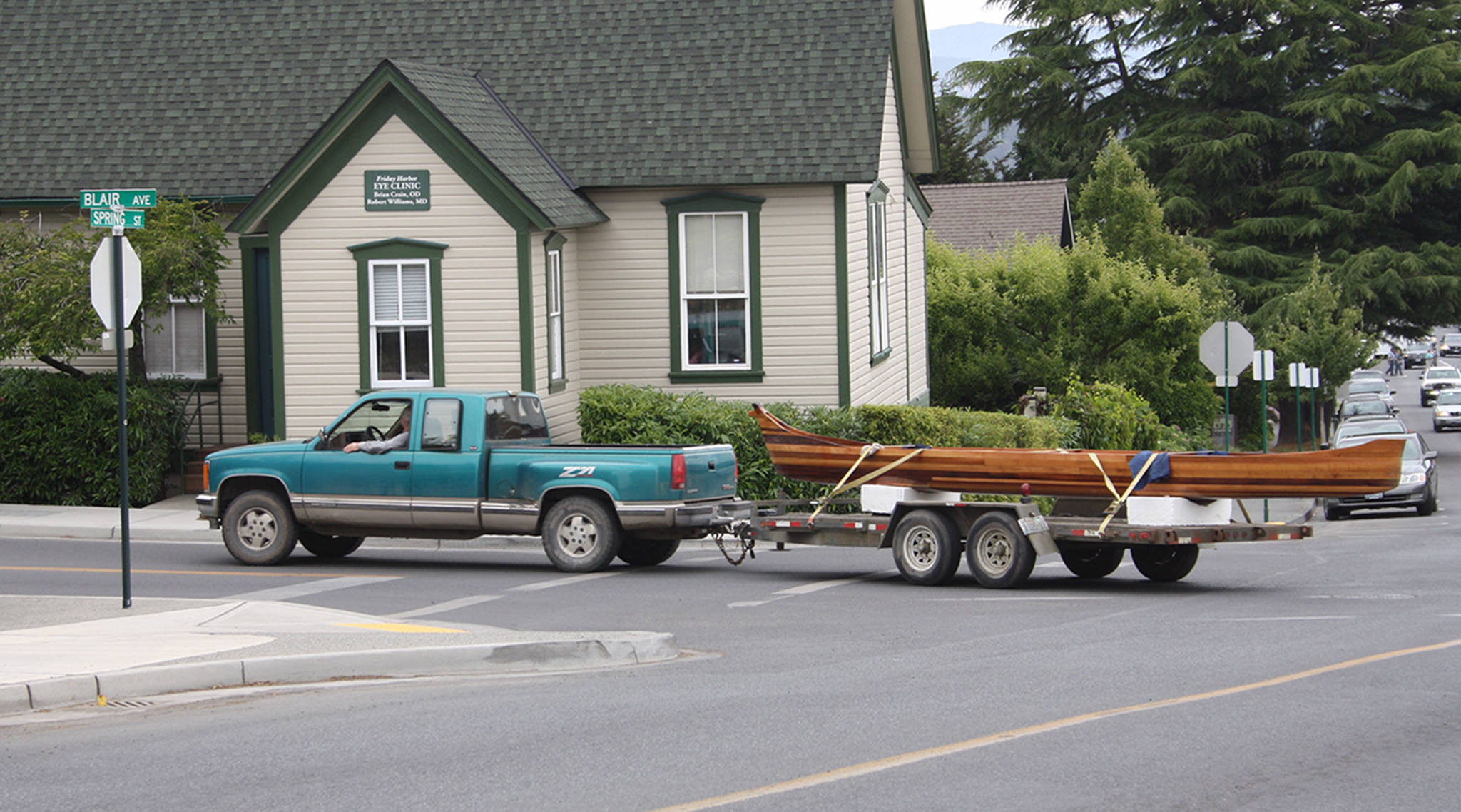 Canoe caravan — islander drives hand-made canoe through town