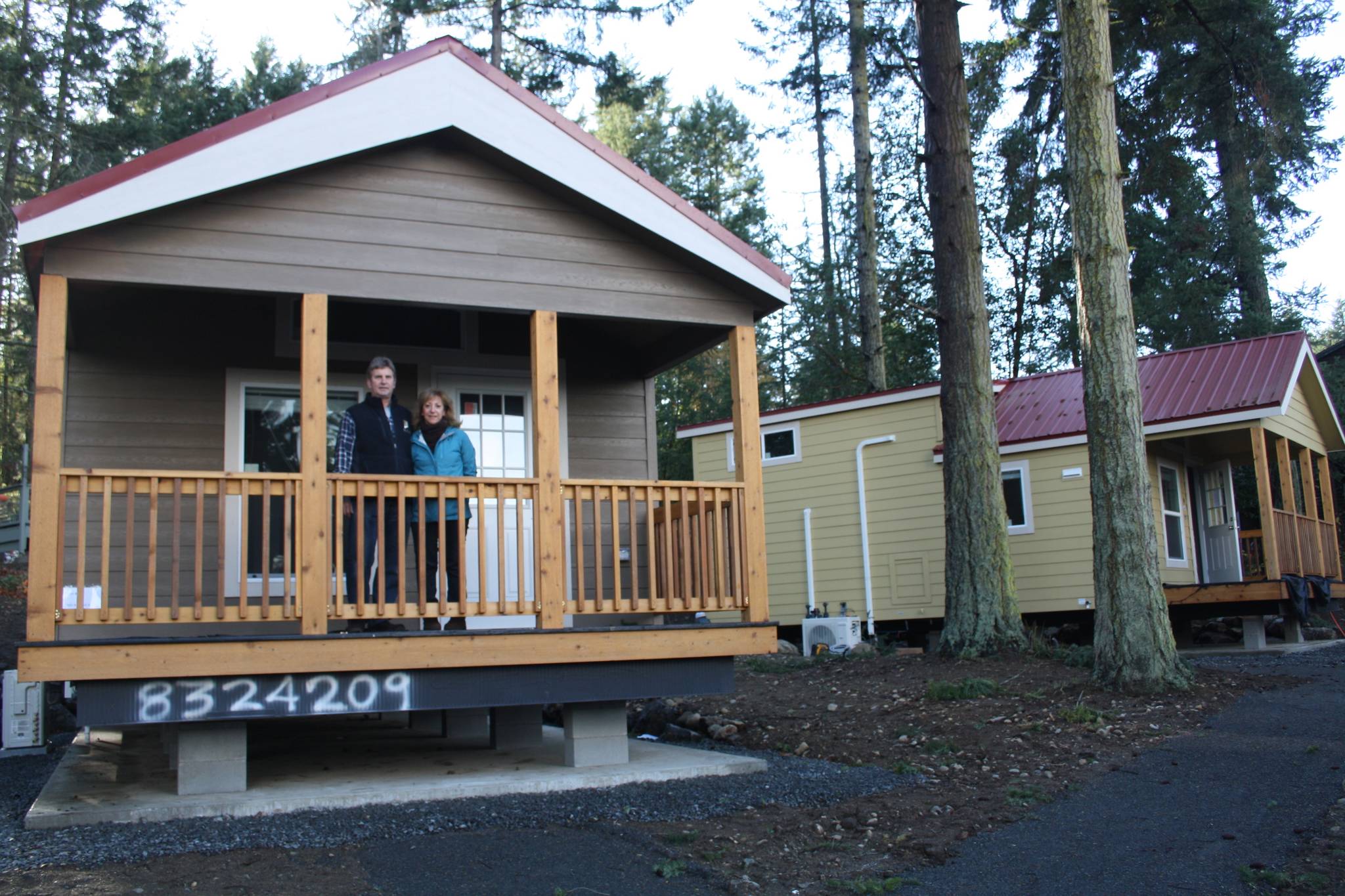 Staff photo/Hayley Day                                Anna Maria de Freitas and David Pass stand on the covered deck of a tiny house they will rent out in Friday Harbor. Each house comes with a 90-square-foot covered deck in the front.