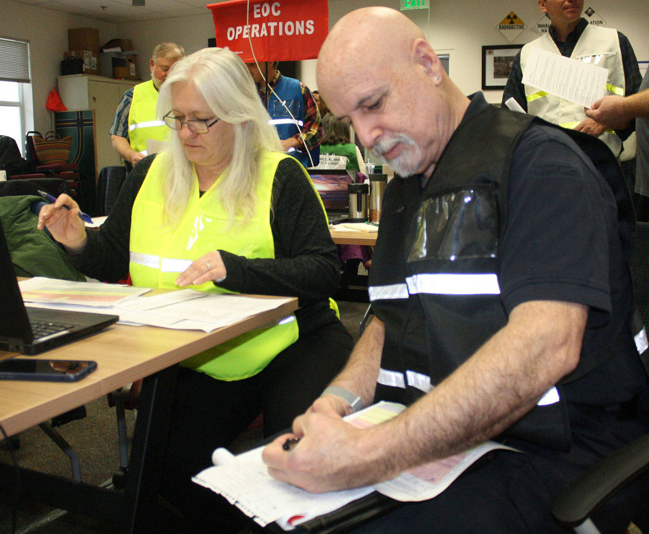 Staff photo/Hayley Day                                Shelli Edwards, with San Juan County Public Works, and Jim McCorison, with Orcas Fire, work on the logistics team at the March 8 San Juan County training.