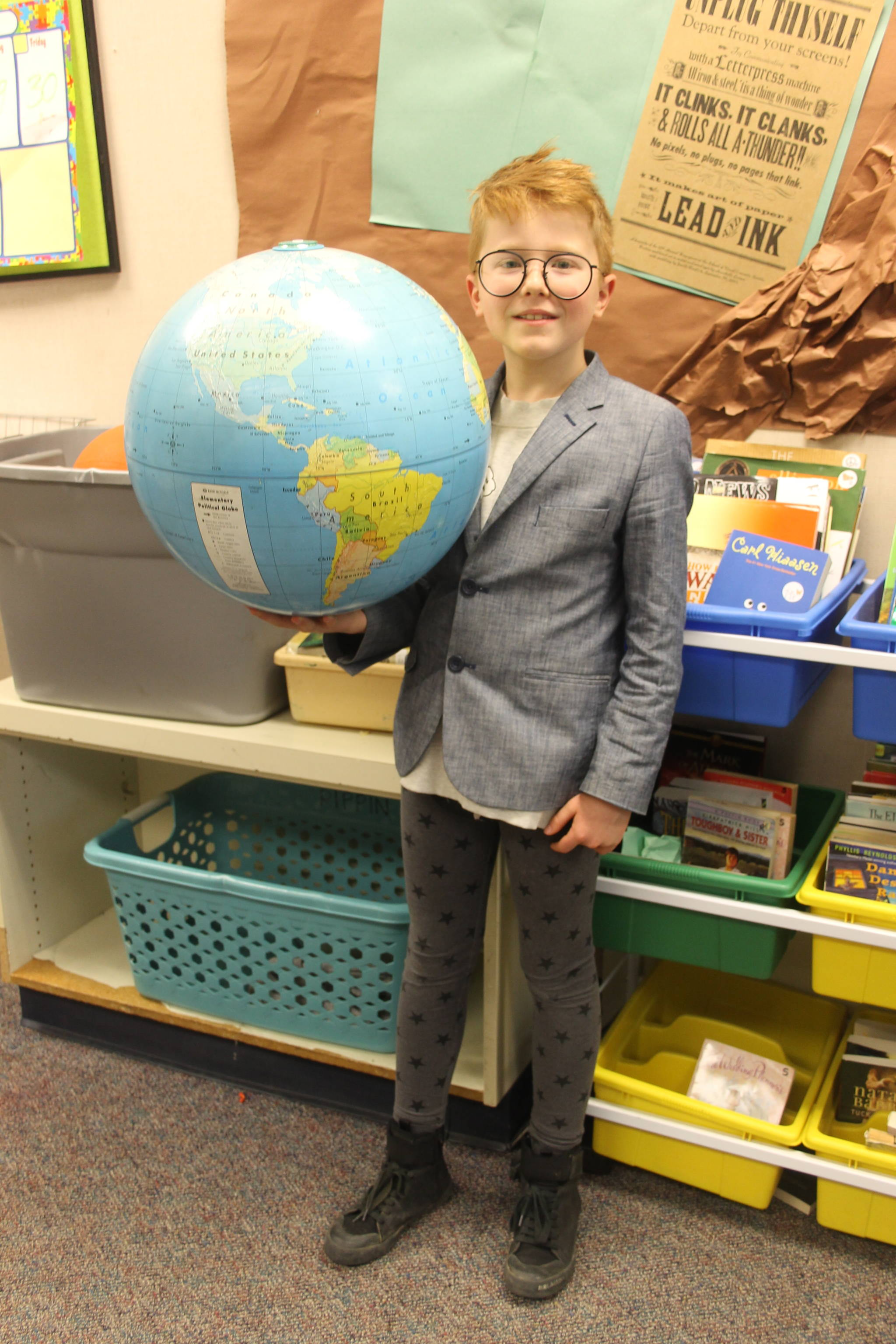 Staff photo/Heather Spaulding                                Henry Jensen holds a globe.