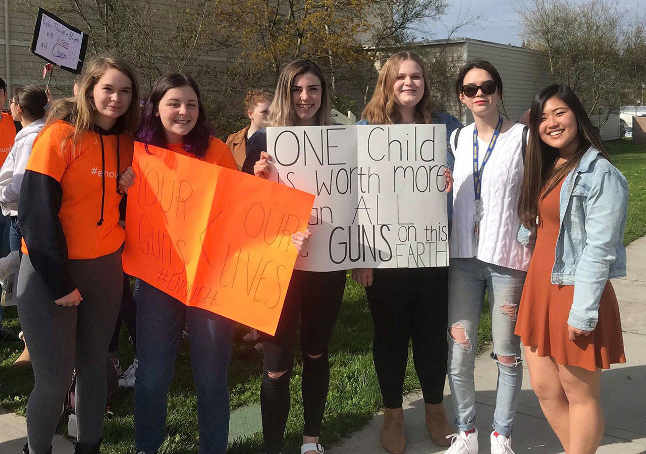 Contributed photo                                Students hold signs during the April 20 walkout.