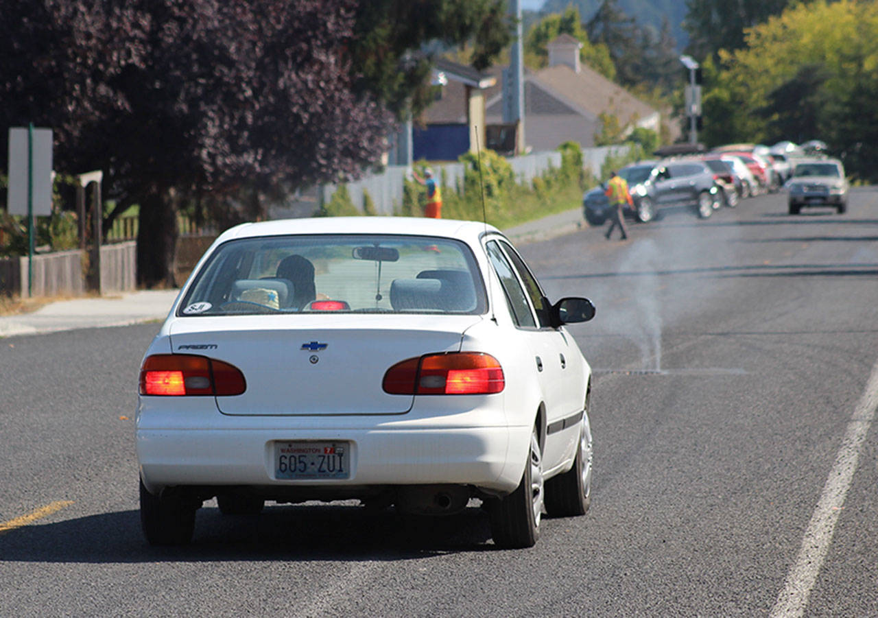 Staff photo/Hayley Day                                Smoke seeps through a manhole on Park Street in Friday Harbor.