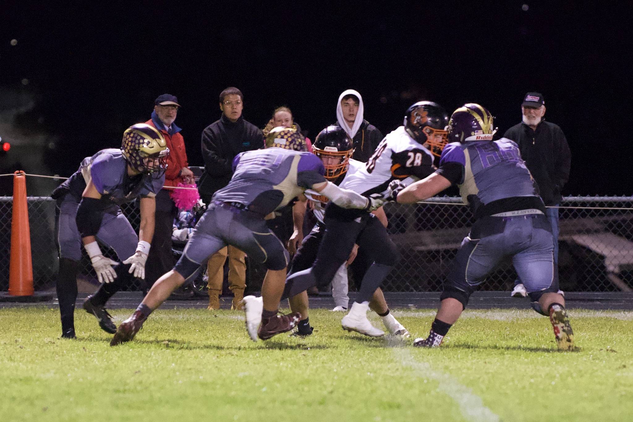 Wolverines Ty Vague, No. 65, and Weston Swirtz, No. 68, put the stop on the Tigers’ running back. (John Stimpson/contributed photo)