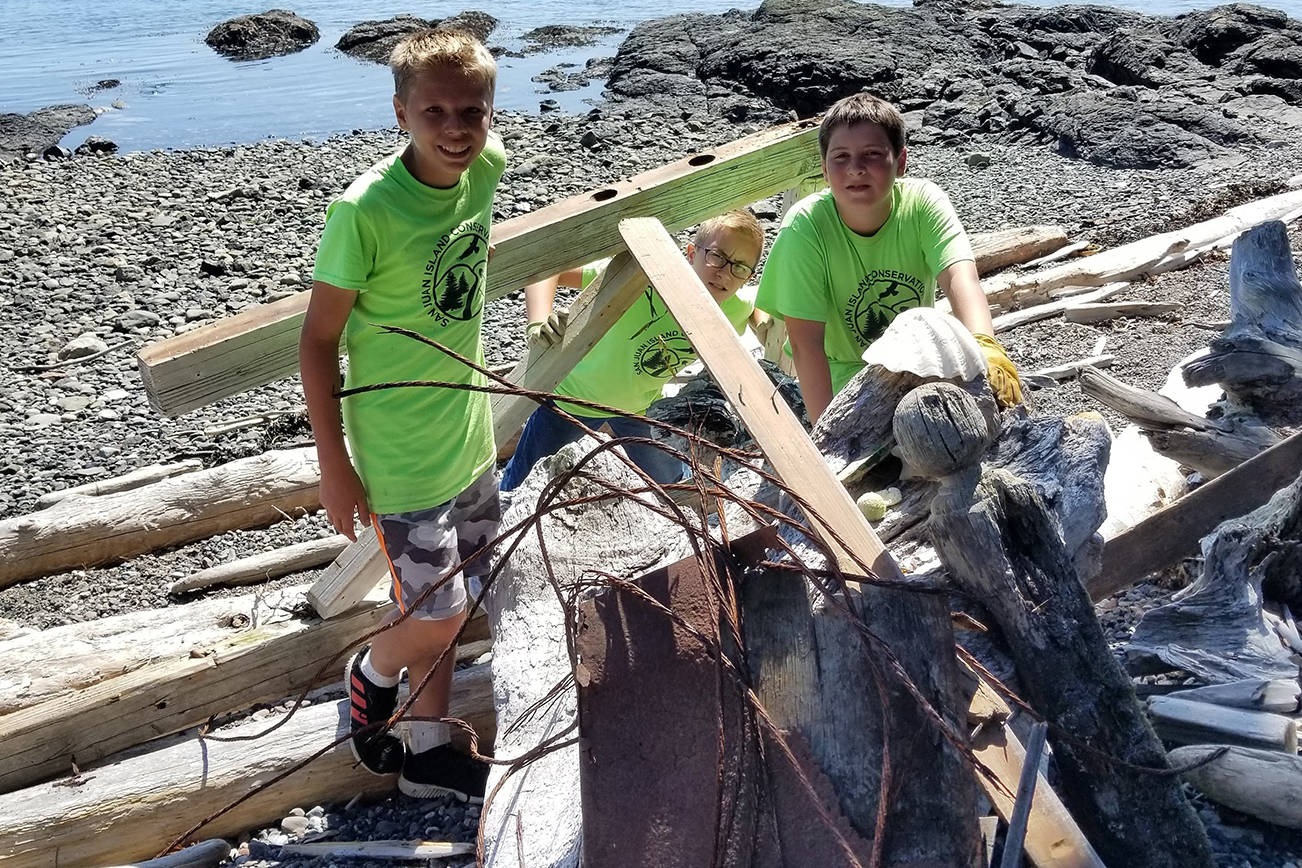 Brendan Reiff, Malachi Cullen and Aiden Greene participate in a Youth Conservation Corpse beach clean-up at Jackson Beach in July 2019. (Contributed photo)