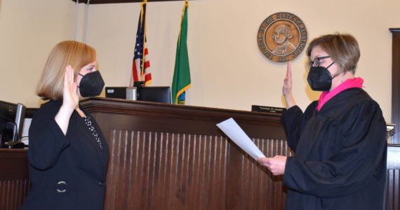 Kelley Balcomb-Bartok\ Staff photo
San Juan District Court Judge Carolyn M. Jewett officially returns to the bench following being sworn in by Superior Court Judge Kathryn “Katie” Loring Dec. 30.