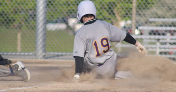 Heather Spaulding Staff photo
Freshman Joseph Holt comes slides into homeplate.