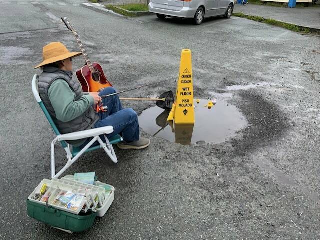 Contributed photo
Tom Henry tries his hand at fishing in the Post Office pot hole.