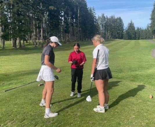 Contributed photo
Morgan Douglass, right, wins a trip to the high school state tournament in a sudden death playoff against Talynn Marquez Kitsap and Alyssa Pingle MVC.