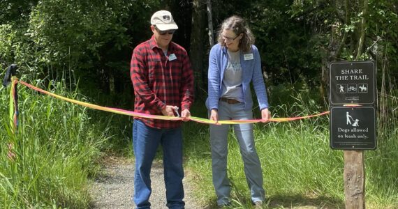 Staff photo / Isabel Ashley
Director of the San Juan County Conservation Land Bank, Lincoln Bormann (left), and Conservation Director of the San Juan Preservation Trust, Vickie Edwards (right), at the ribbon cutting ceremony for the new trail on the Land Bank’s Cady Mountain Preservation