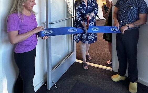 Heather Spaulding \ Staff phot
o Anna Maria de freitas, Chamber Board member and Roberto Moya, Chamber President, hold the ribbon as April Randall cuts it.