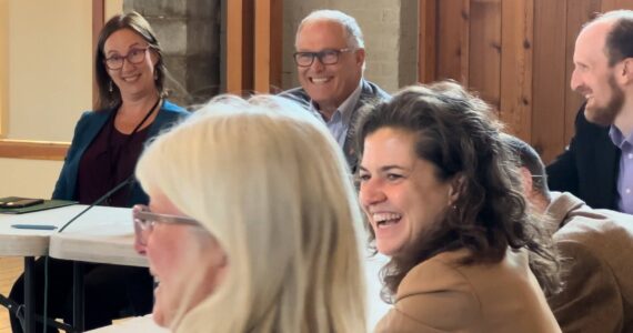 Contributed photo by Jeff Noedel at San Juan Today
San Juan County Council Chair Jane Fuller and Gov. Jay Inslee are all smiles at additional funding for local transportation.