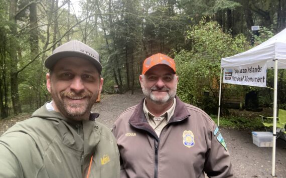 <em>WDFW district biologist Kurt Licence and BLM staff at the kiosk near Watmough Bay on southern Lopez Island. </em>