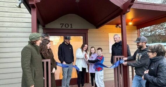 Heather Spaulding \ Staff photo
Kayla Roe cuts the ribbon with the assistance of her family, while Chamber board and staff watch.