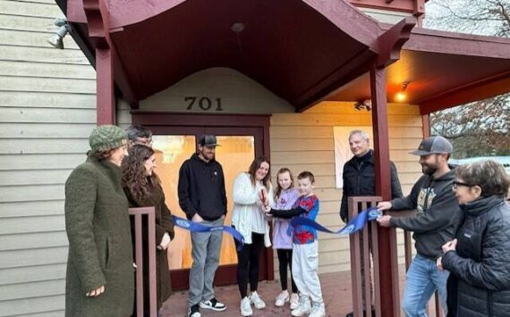 Heather Spaulding \ Staff photo
Kayla Roe cuts the ribbon with the assistance of her family, while Chamber board and staff watch.