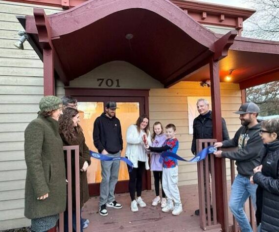 Heather Spaulding \ Staff photo
Kayla Roe cuts the ribbon with the assistance of her family, while Chamber board and staff watch.