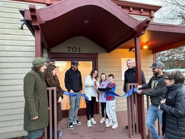 Heather Spaulding \ Staff photo
Kayla Roe cuts the ribbon with the assistance of her family, while Chamber board and staff watch.