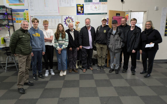 Rotary member Scott Sluis (far left; in center, Rotarians Chris Haynes and President Karl Eberhard; third from right, Sam Garson, science teacher/program director; far right, Andrea Hillman, principal; all surrounded by illustrious STEAM students.