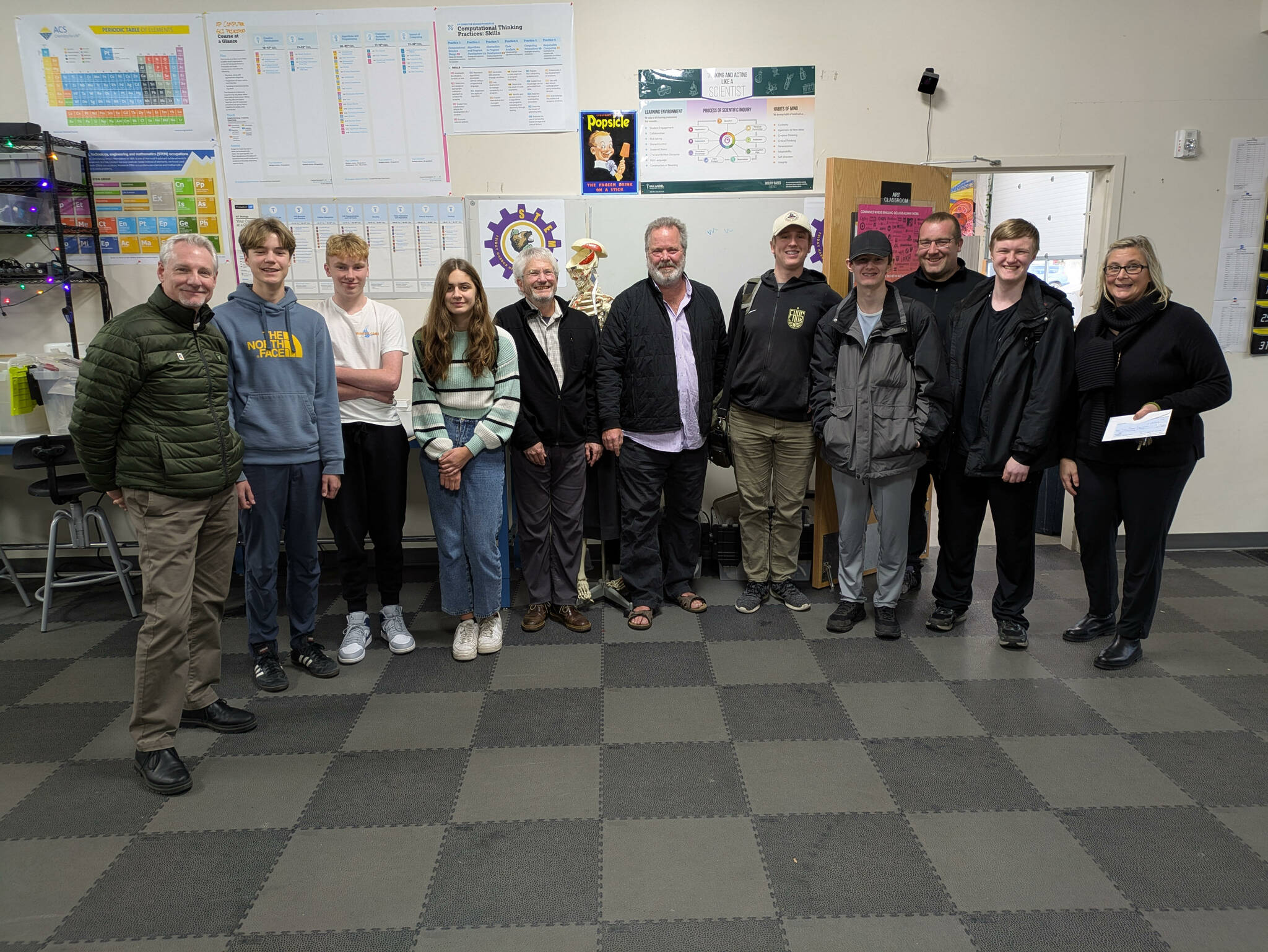 Rotary member Scott Sluis (far left; in center, Rotarians Chris Haynes and President Karl Eberhard; third from right, Sam Garson, science teacher/program director; far right, Andrea Hillman, principal; all surrounded by illustrious STEAM students.